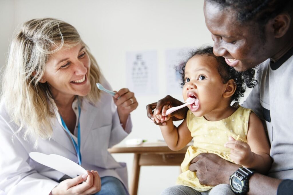 Pediatric dentist helping kids maintain healthy smiles