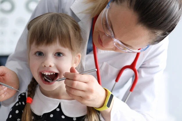 Pediatric dentist caring for a child’s smile